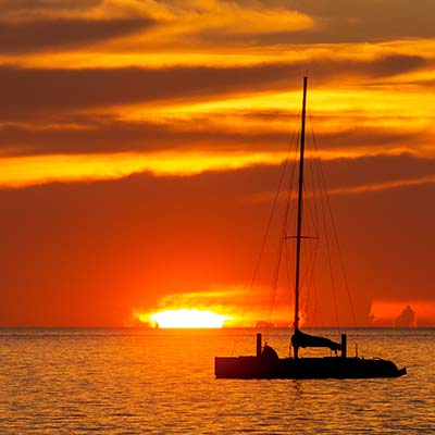 Watch the sun sink below the horizon on a barefoot sail. You may even see the “green flash”!
