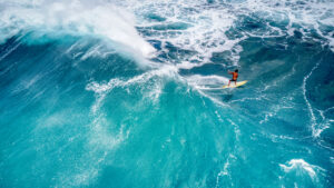 When is the best time to visit Hawaii. Surfer on a big wave