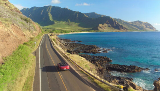 Aerial:,Red,Convertible,Car,Driving,Along,The,Picturesque,Coastal,Road